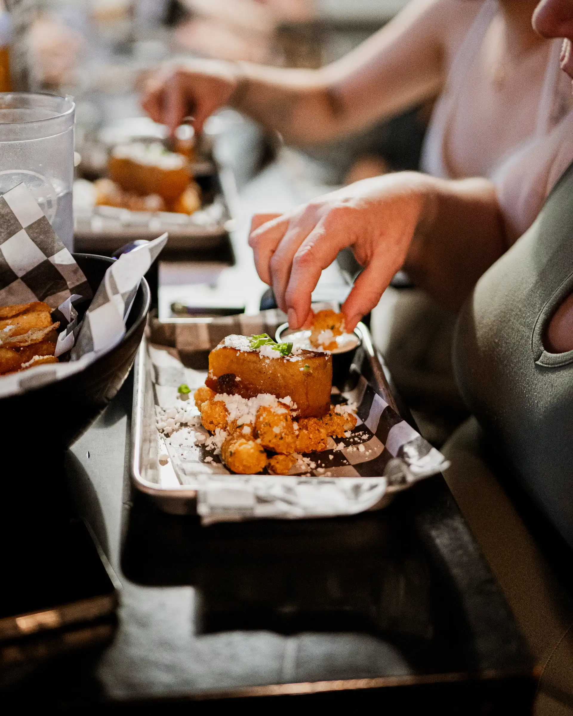 A plated dish with a cheese pour at a Doobie infused dinner.