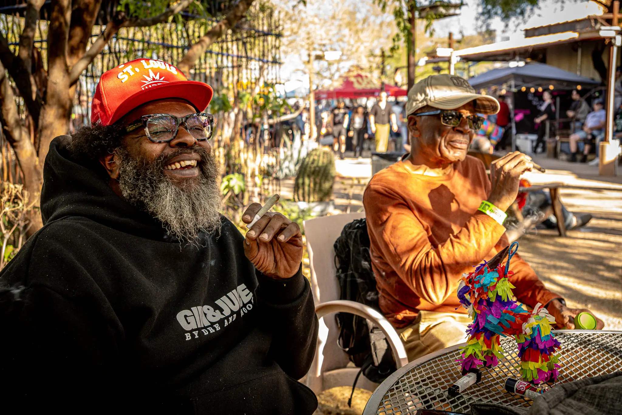 Friends laughing together outdoors at a Doobie members event.